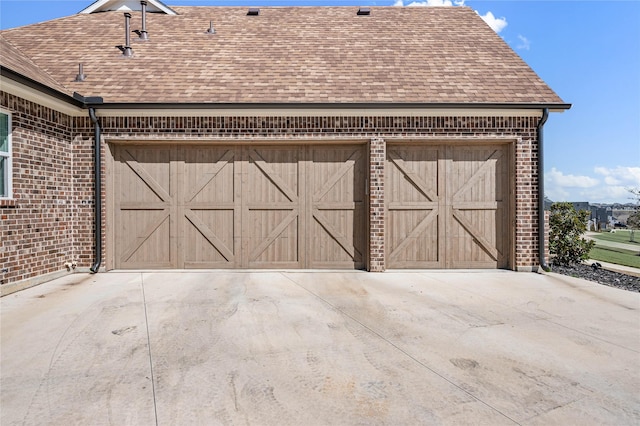 garage featuring concrete driveway