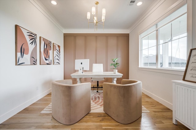 office featuring visible vents, light wood-style flooring, radiator heating unit, ornamental molding, and a chandelier