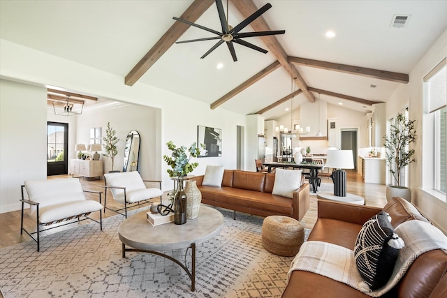 living area featuring light wood finished floors, visible vents, lofted ceiling with beams, a notable chandelier, and recessed lighting