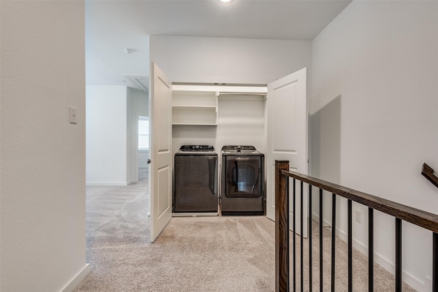 spacious closet with light colored carpet and separate washer and dryer