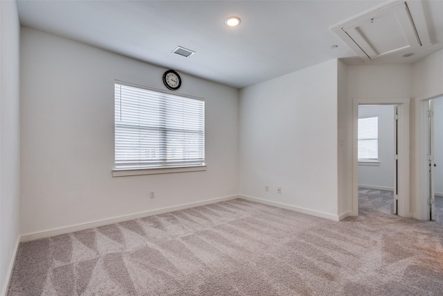 empty room featuring light carpet