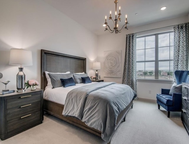 bedroom with light colored carpet and a notable chandelier