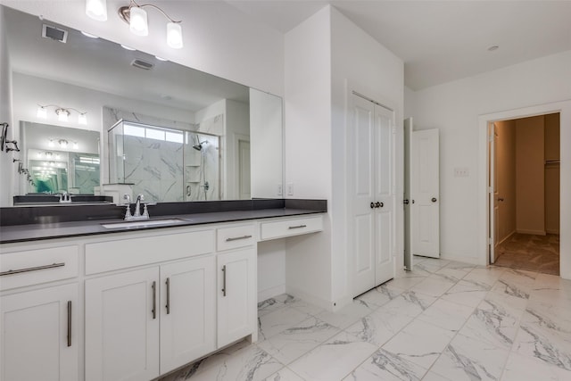 bathroom featuring vanity and an enclosed shower