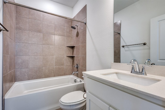 full bathroom featuring tiled shower / bath combo, vanity, and toilet