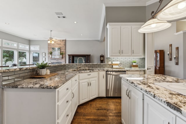 kitchen with white cabinetry, sink, backsplash, stainless steel dishwasher, and crown molding