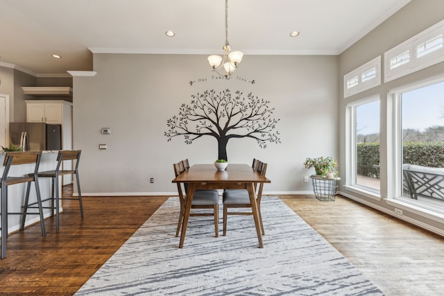 dining area featuring a notable chandelier, ornamental molding, and dark wood-type flooring