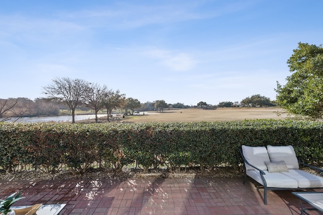 view of yard featuring a rural view and a patio area