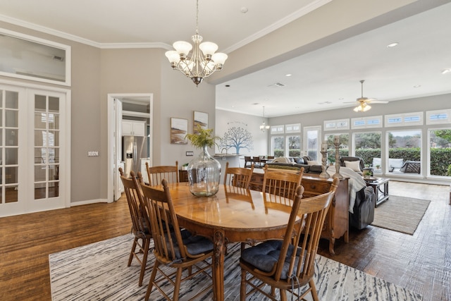 dining room with hardwood / wood-style flooring, ornamental molding, french doors, and ceiling fan with notable chandelier