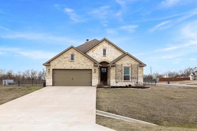 view of front of property featuring a garage and a front lawn