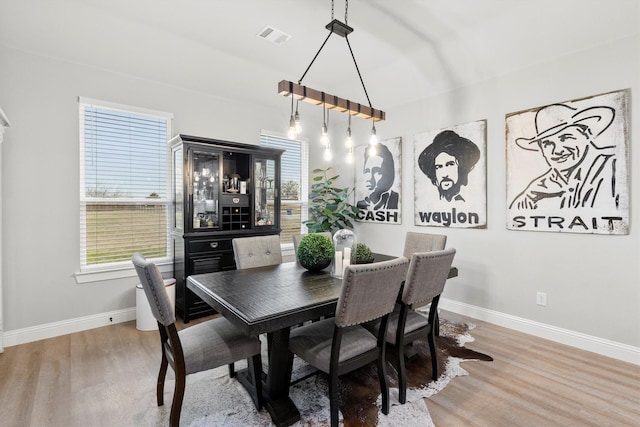 dining space with hardwood / wood-style flooring and a wealth of natural light