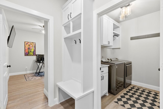 mudroom with ceiling fan, washer and dryer, and light wood-type flooring