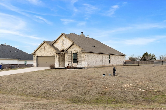 french country style house with a garage