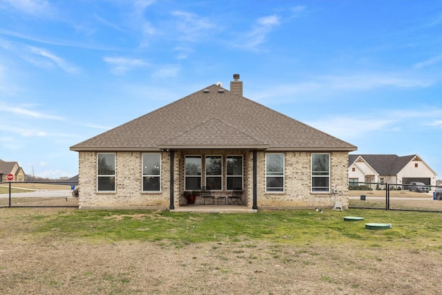 rear view of house featuring a yard and a patio area