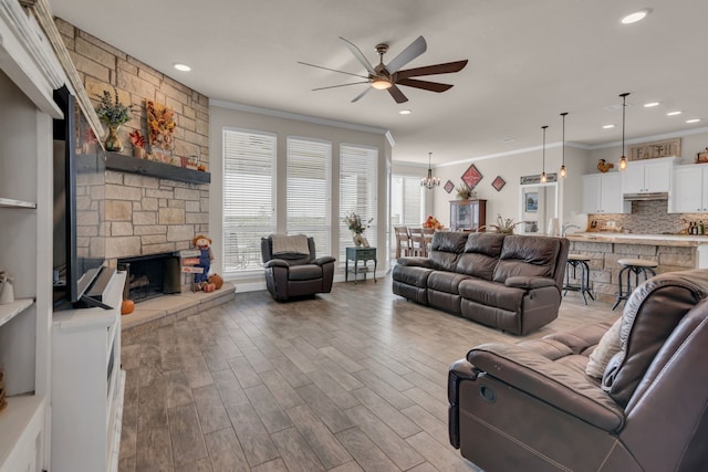 7728 County Road 1205, Rio Vista, TX 76093 - living area featuring ceiling fan, plenty of natural light, crown molding, a fireplace, and wood finished floors