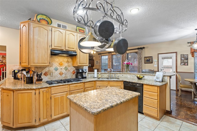 kitchen with sink, black appliances, kitchen peninsula, and light stone countertops