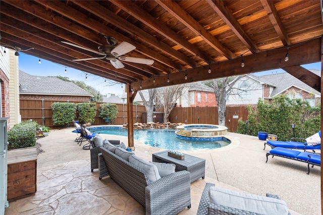 view of patio / terrace featuring a swimming pool with hot tub and ceiling fan