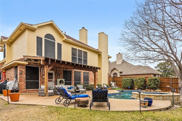 rear view of property featuring a swimming pool with hot tub, outdoor lounge area, and a patio area