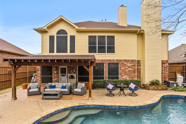 back of house featuring a fenced in pool, an outdoor hangout area, and a patio