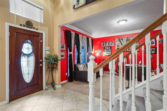 entrance foyer with crown molding, tile patterned floors, and a textured ceiling