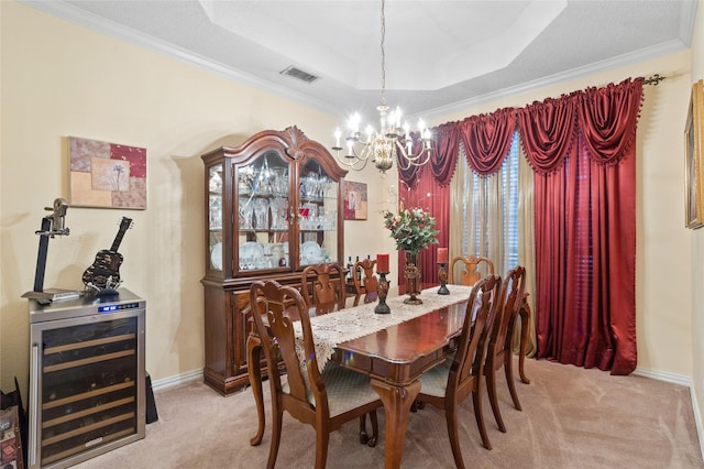 dining area with an inviting chandelier, light colored carpet, a tray ceiling, and beverage cooler