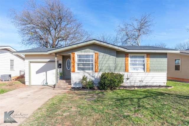 ranch-style home featuring a garage, central AC, and a front yard