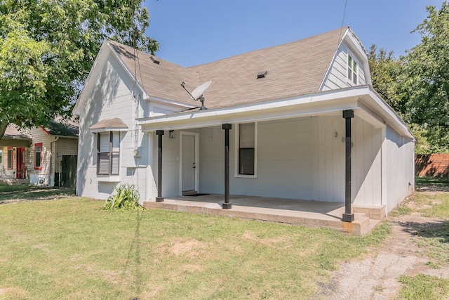 back of property with a patio and a lawn