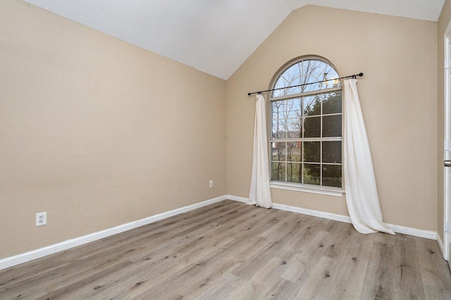 unfurnished room with lofted ceiling and light hardwood / wood-style floors