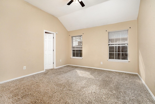 carpeted spare room with lofted ceiling and ceiling fan