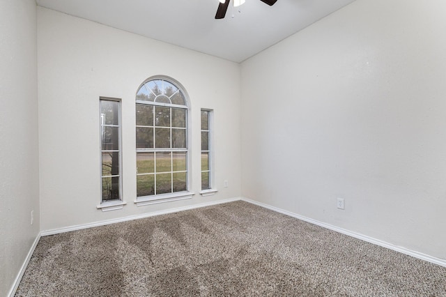 carpeted spare room with ceiling fan