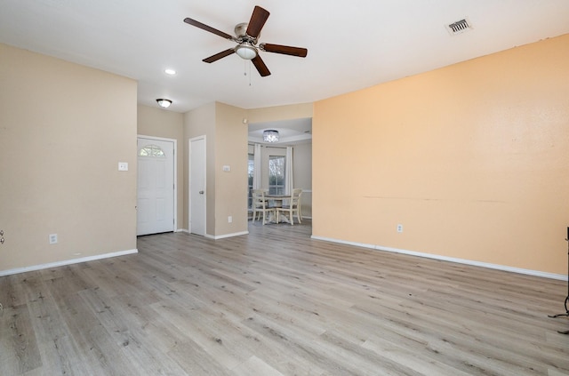 empty room with ceiling fan and light wood-type flooring