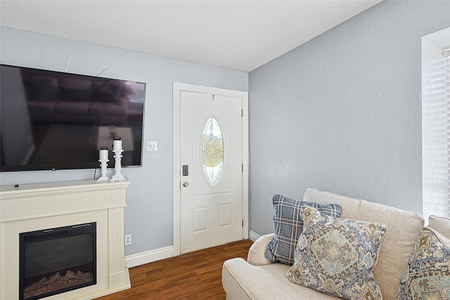 entryway featuring dark hardwood / wood-style floors and a textured ceiling