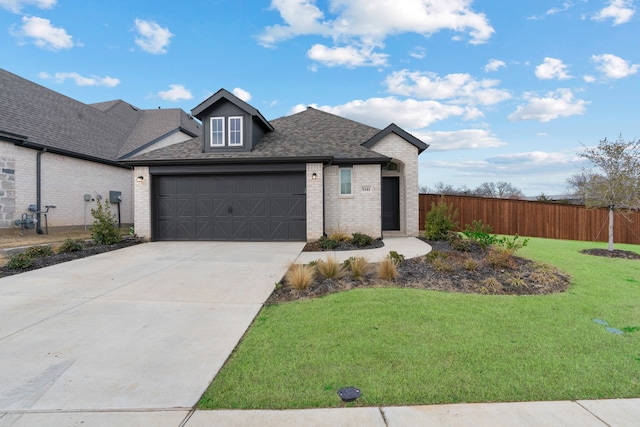 view of front of property featuring a garage and a front yard