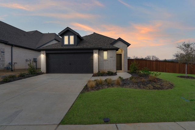 view of front facade featuring a garage and a lawn