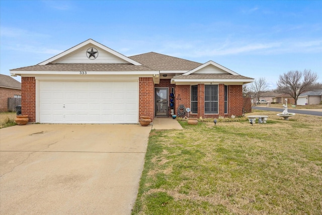 ranch-style home featuring a garage, brick siding, driveway, roof with shingles, and a front lawn