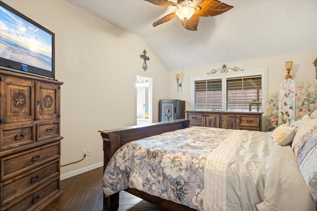 bedroom with lofted ceiling, ceiling fan, and baseboards