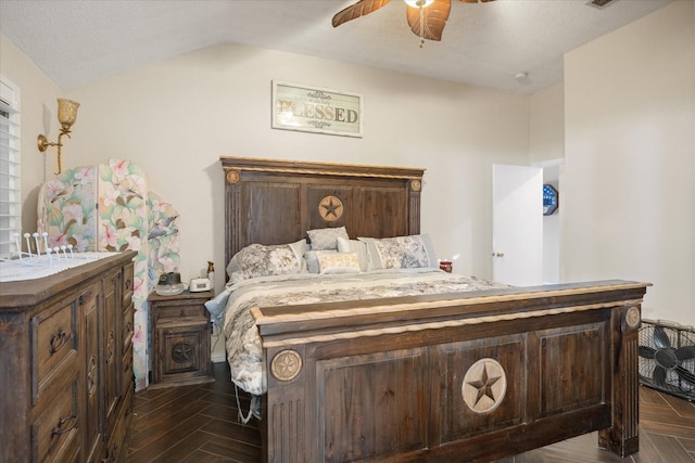 bedroom with a ceiling fan, lofted ceiling, and a textured ceiling