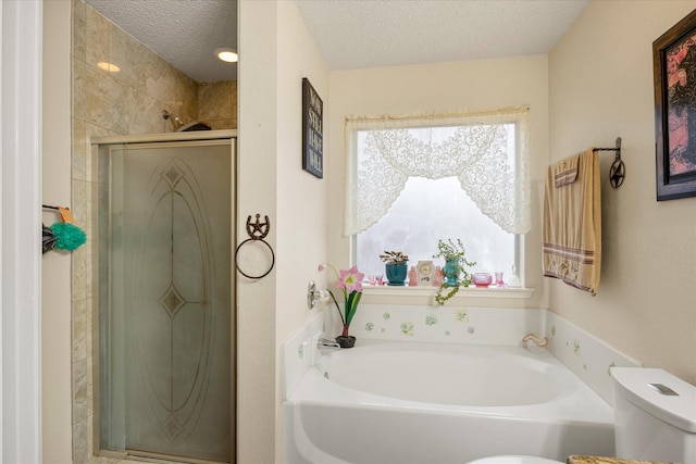 full bath with toilet, a garden tub, a textured ceiling, and a stall shower