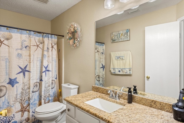 full bath with visible vents, a textured wall, toilet, a textured ceiling, and vanity