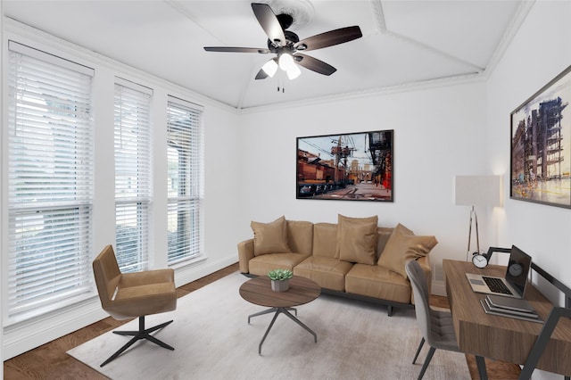 living room featuring a ceiling fan, crown molding, wood finished floors, and baseboards