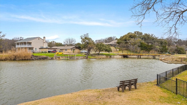 property view of water featuring fence