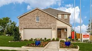 view of front of property with a garage and a front yard