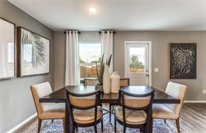 dining space with wood-type flooring