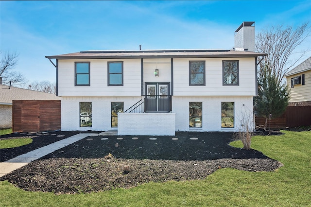 raised ranch featuring a front yard