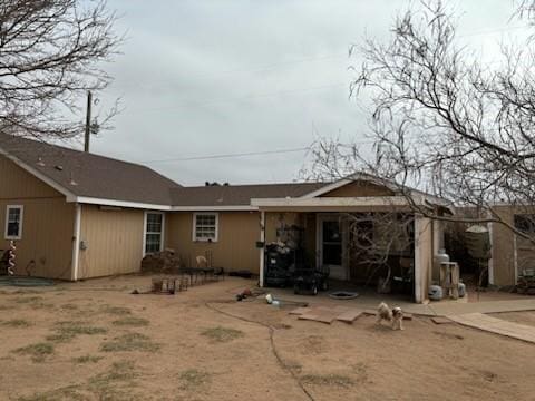 back of property with a patio