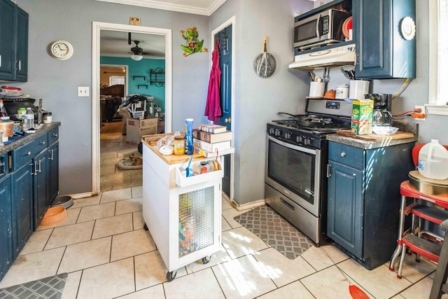 kitchen with light tile patterned flooring, blue cabinetry, appliances with stainless steel finishes, and ornamental molding