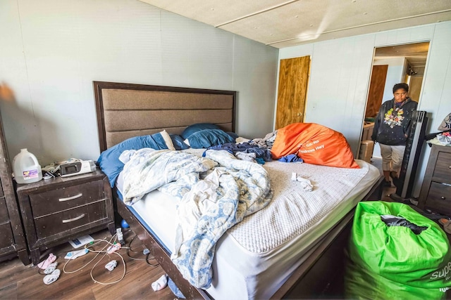 bedroom with dark wood-type flooring