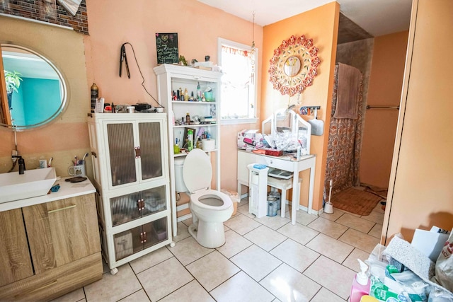 bathroom featuring sink, tile patterned flooring, and toilet