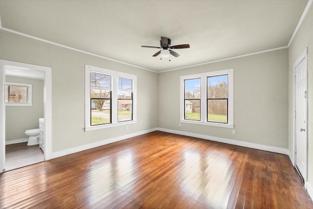 unfurnished bedroom featuring multiple windows, crown molding, and dark wood-type flooring