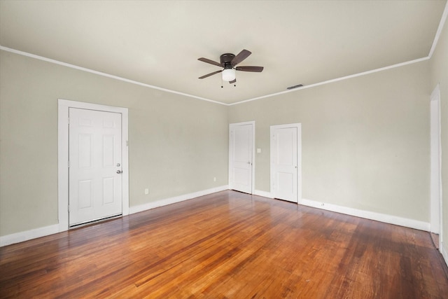 unfurnished room featuring dark wood-type flooring and ornamental molding