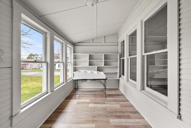 unfurnished sunroom featuring vaulted ceiling